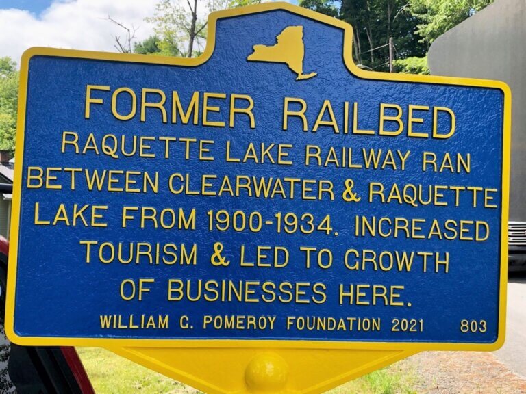 New York State historical marker for former railbed, Raquette Lake, New York.