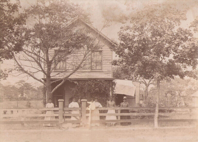 A restored circa 1900 historical photograph of the Mary E. Bell house and members of the Bell family in Center Moriches, New York.