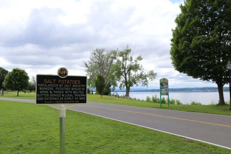 The Hungry for History salt potatoes marker with Onondaga Lake in the distance.