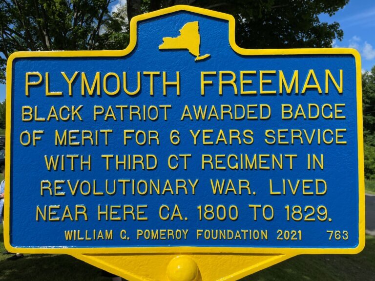 Historical marker commemorating Plymouth Freeman, recipient of the Badge of Merit for service during Revolutionary War.