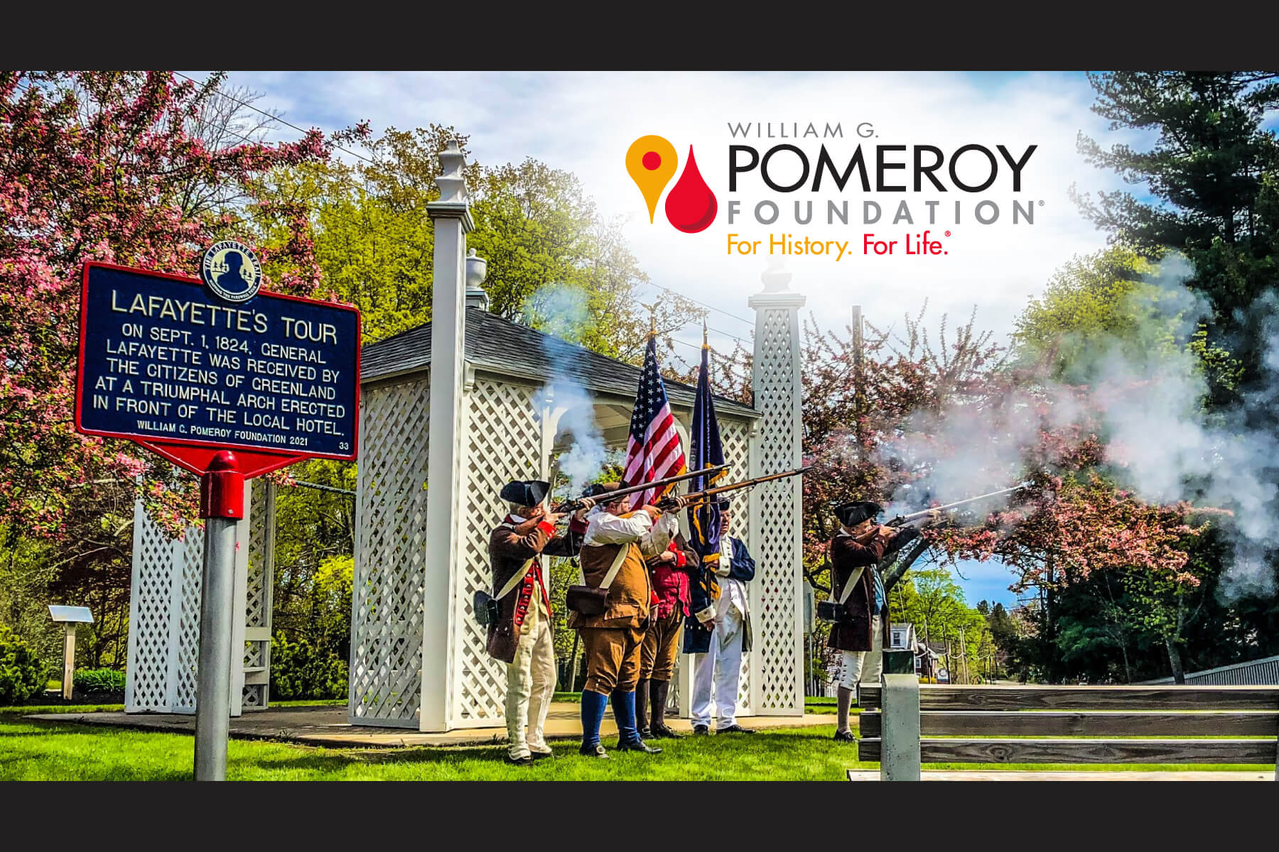 The cover of the William G. Pomeroy Foundation Booklet with men dressed as colonial soldiers aim their rifles towards the sky while standing next to a Historic marker