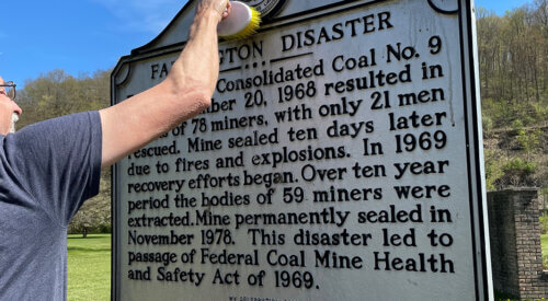 Cleaning a marker in West Virginia for National Historic Marker Day 2021.