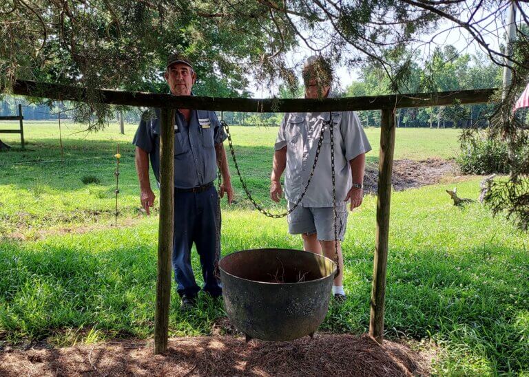 Paul and Randall Winburn of Winburn Farms, Galivants Ferry, SC, with cast iron wash pot they remember their grandmother, Mattie Griggs Winburn, used to cook chicken bog.